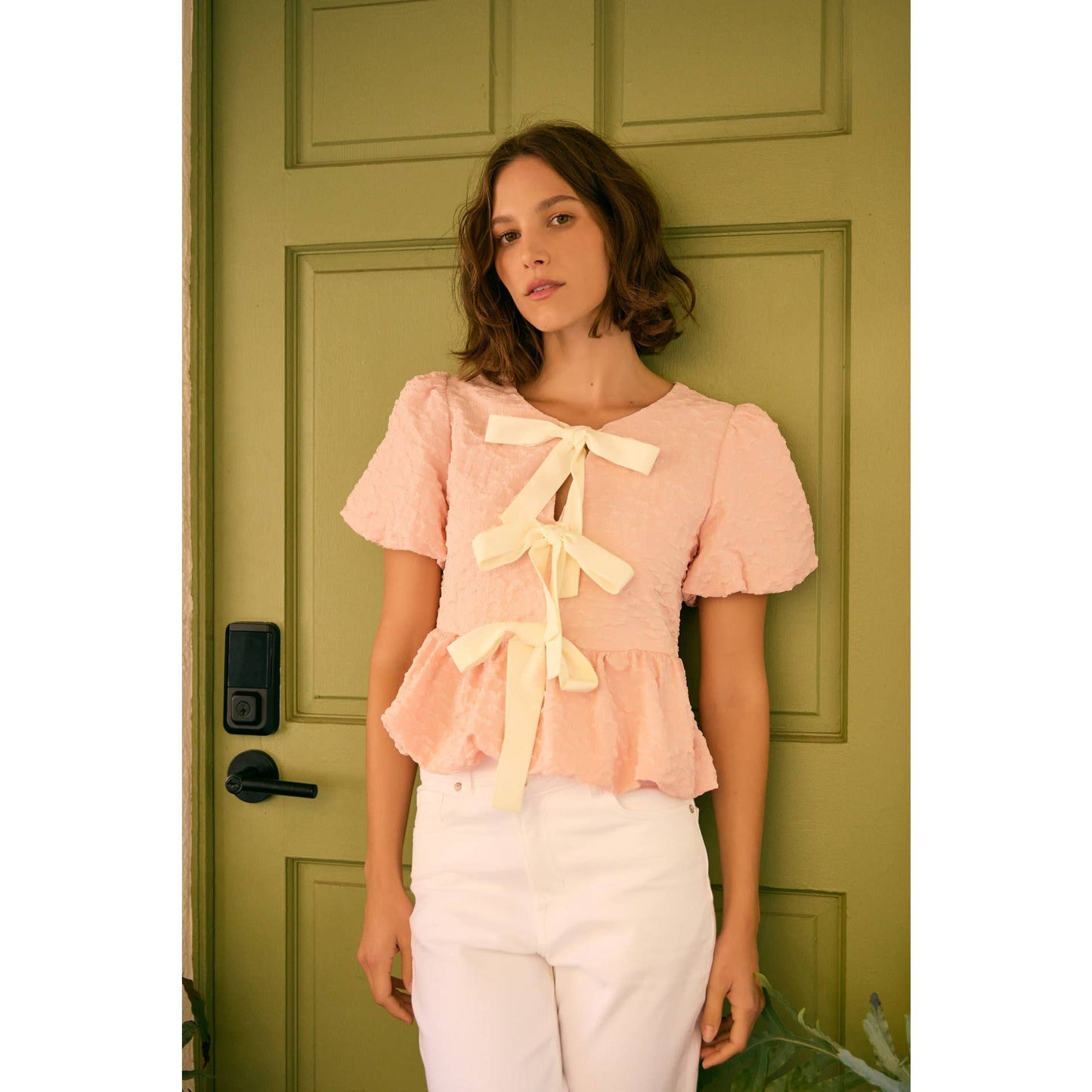 BUBBLE PEPLUM TOP WITH TEXTURED FABRIC AND BOW