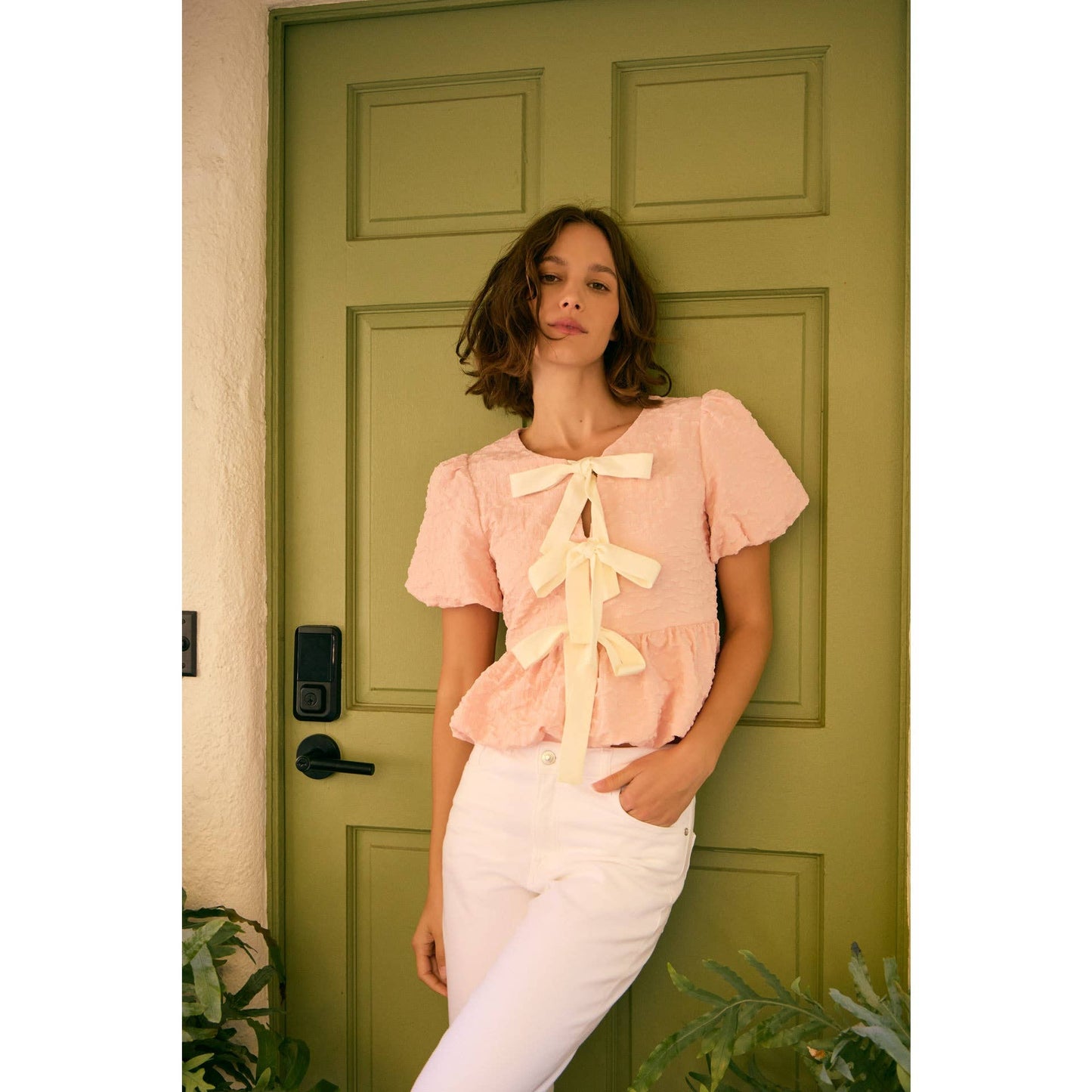 BUBBLE PEPLUM TOP WITH TEXTURED FABRIC AND BOW